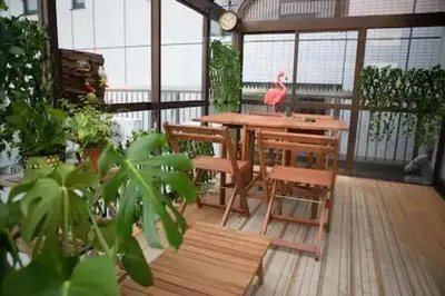 a patio with a table and chairs on a balcony at SY-HOTEL Kuramae 5mins \u673a\u573a\u76f4\u8fbe \u4ea4\u901a\u4fbf\u5229 \u8535\u524d5\u5206\u949f in Tokyo