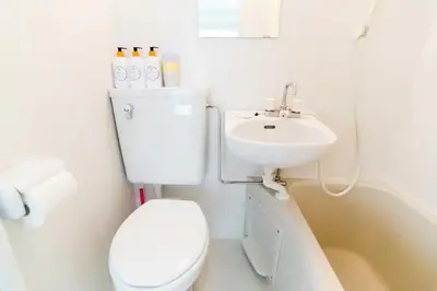 a white bathroom with a toilet and a sink at SY-HOTEL Kuramae 5mins \u673a\u573a\u76f4\u8fbe \u4ea4\u901a\u4fbf\u5229 \u8535\u524d5\u5206\u949f in Tokyo