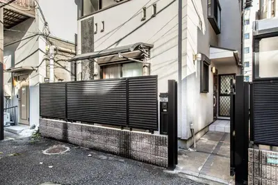 a gate on the side of a building at \u5317\u6c60\u888b\u6238\u5efa in Tokyo
