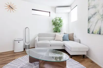 a living room with a couch and a glass table at First Choice in Tokyo