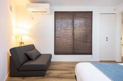 a bedroom with a chair and a window at First Choice in Tokyo