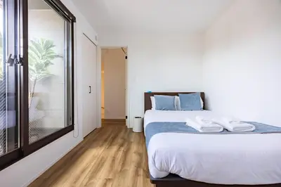 a bedroom with a bed and a large window at First Choice in Tokyo