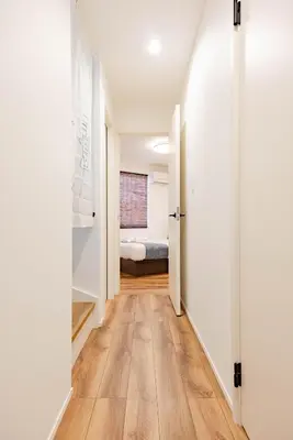 a hallway with a bed in a room at First Choice in Tokyo