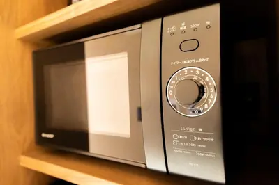 a microwave oven sitting on top of a shelf at VISTALIA - Vacation STAY 18151 in Tokyo