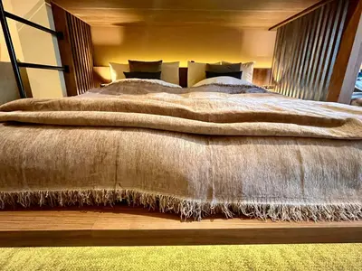a bedroom with a large bed with a brown blanket at VISTALIA - Vacation STAY 18151 in Tokyo