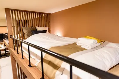 a bedroom with a bed with a wooden frame at VISTALIA - Vacation STAY 18151 in Tokyo