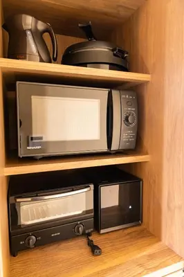 a microwave and a toaster oven in a cabinet at VISTALIA - Vacation STAY 18150 in Tokyo