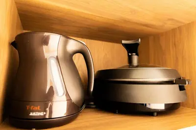 a tea pot and kettle sitting on a shelf at VISTALIA - Vacation STAY 18150 in Tokyo