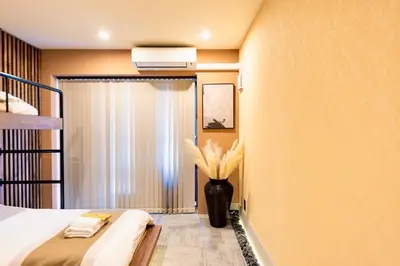 a bedroom with a bed and a vase with flowers at VISTALIA - Vacation STAY 18150 in Tokyo