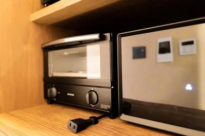 a microwave sitting on a counter with a camera next to it at VISTALIA - Vacation STAY 18153 in Tokyo