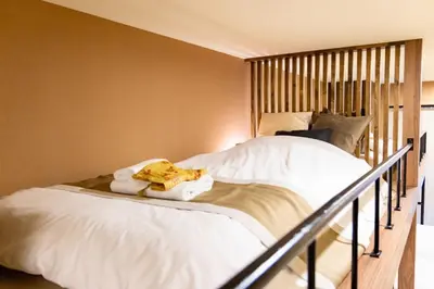 a bed with white sheets and towels on it at VISTALIA - Vacation STAY 18153 in Tokyo