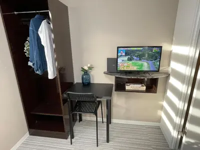 a room with a table and a television in a room at COMMA HOUSE Shinjuku 2UNITS 2122 in Tokyo