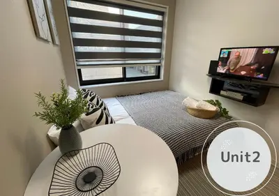 a living room with a white table and a window at COMMA HOUSE Shinjuku 2UNITS 2122 in Tokyo