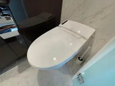 a white toilet in a bathroom with marble walls at COMMA HOUSE Shinjuku 2UNITS 2122 in Tokyo