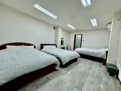 a bedroom with two beds and a room with skylights at Kobayashi Building - Vacation STAY 82335v in Tokyo