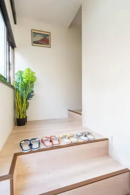a row of pairs of glasses sitting on a wooden shelf at \u65e5\u672c\u5bb6\u5c4b\u6c11\u6cca in Tokyo