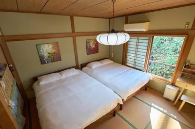 a bedroom with a large bed and a window at yoyogi house jellyne in Tokyo