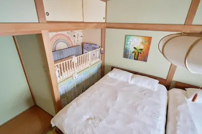 a small room with a bed and a baby crib at yoyogi house jellyne in Tokyo