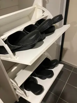 a row of shoes on a shelf in a closet at HW HILLS Komagome 101 by Tranova in Tokyo