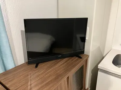a flat screen tv sitting on top of a wooden stand at HW HILLS Komagome 101 by Tranova in Tokyo