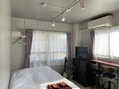 a bedroom with a bed and a desk with a computer at HW HILLS Komagome 401 by Tranova in Tokyo