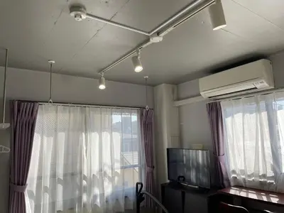 a room with a tv and a window with curtains at HW HILLS Komagome 401 by Tranova in Tokyo