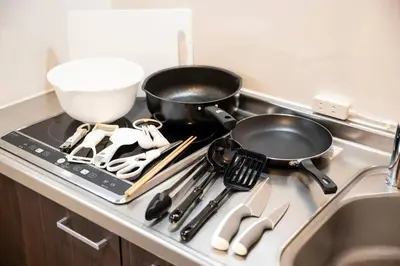 a kitchen stove with a pans and utensils on it at Craft202 \u6d45\u8349 \u30b9\u30ab\u30a4\u30c4\u30ea\u30fc\u8fd1\u304f \u6771\u4eac\u89b3\u5149\u306b\u6700\u9069 \u7a7a\u6e2f\u304b\u3089\u30a2\u30af\u30bb\u30b9\u826f\u597d \u7121\u6599WiFi in Tokyo