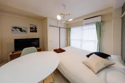 a bedroom with a large white bed and a window at Kimura House by Tranova in Tokyo