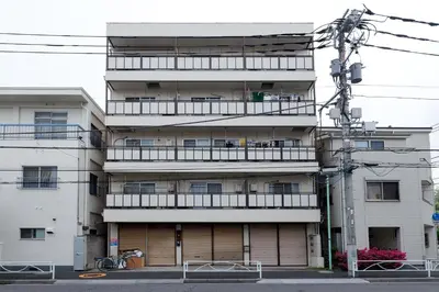 an apartment building with a balcony on the side of it at Kimura House by Tranova in Tokyo