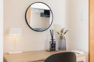 a table with a mirror and a lamp and a chair at Tokyo Kitasen 4 in Tokyo