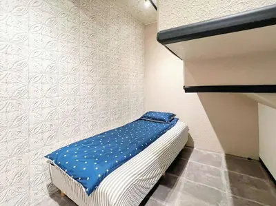 a small room with a bed with blue sheets at Easily to Nishi-Nippori Shibuya Asakusa For 10 in Tokyo