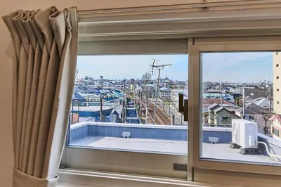 a window with a view of a city at New\u6771\u4eac\u3067\u5bcc\u58eb\u5c71\u304c\u898b\u3048\u308bPentohouse ZEN \u5965\u6ca2\u99c51\u5206\u81ea\u7531\u30f6\u4e18\u5f92\u6b696\u5206\u6e0b\u8c37\u96fb\u8eca15\u5206 in Tokyo
