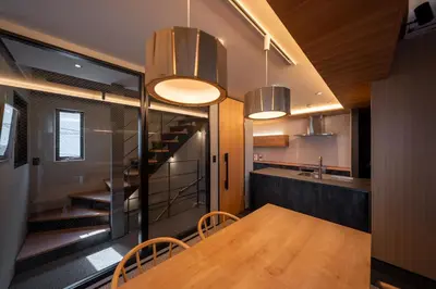 a dining room with a table and some lights at Tokyo Modern Stay Shinjuku in Tokyo