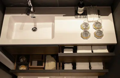 a bathroom sink with two glasses and towels at Tokyo Modern Stay Shinjuku in Tokyo