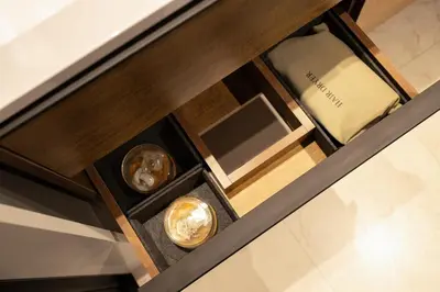 a wooden table with three differentiatesiatesiatesiatesiatesiatesiatesiatesiatesiates at Tokyo Modern Stay Shinjuku in Tokyo