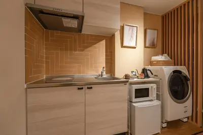 a small kitchen with a sink and a microwave at Tokyo Modern Stay Shinjuku in Tokyo