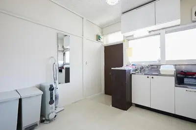 a kitchen with white cabinets and a large window at Okubo Daiichi House2C OD2C in Tokyo