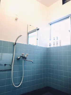 a bathroom with a shower with blue tiles at Okubo Daiichi House2C OD2C in Tokyo