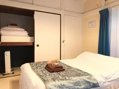 a room with a bed with a teddy bear on it at Okubo Daiichi House 1B OD1B in Tokyo