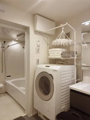 a washer and dryer in a bathroom with a tub at cityhouse\u6c60\u888b in Tokyo