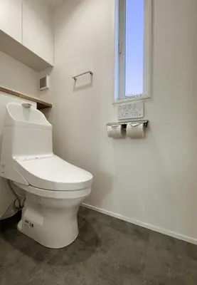 a white bathroom with a toilet and a window at cityhouse\u6c60\u888b in Tokyo