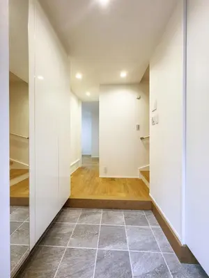 a hallway with white walls and a tile floor at cityhouse\u6c60\u888b in Tokyo