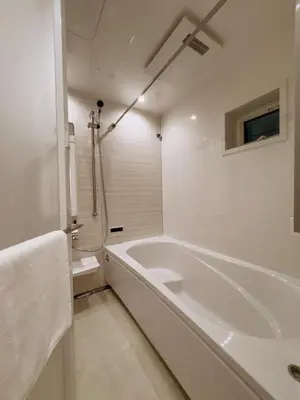 a white bathroom with a tub and a shower at cityhouse\u6c60\u888b in Tokyo