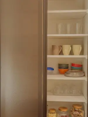 a refrigerator filled with lots of bowls and plates at cityhouse\u6c60\u888b in Tokyo