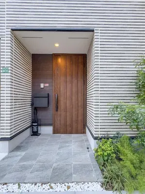 a wooden door on the side of a building at cityhouse\u6c60\u888b in Tokyo
