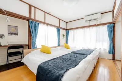 a bedroom with a large bed with yellow pillows at Chelsea Hatsudai 201 CH21 in Tokyo