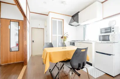 a small kitchen with a table and two chairs at Chelsea Hatsudai 201 CH21 in Tokyo