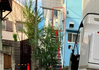 a tree in front of a building next to a building at Chelsea Hatsudai 201 CH21 in Tokyo