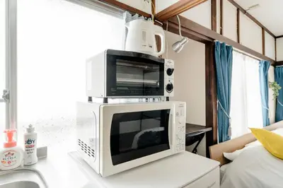 a microwave sitting on top of a kitchen counter at Chelsea Hatsudai 201 CH21 in Tokyo