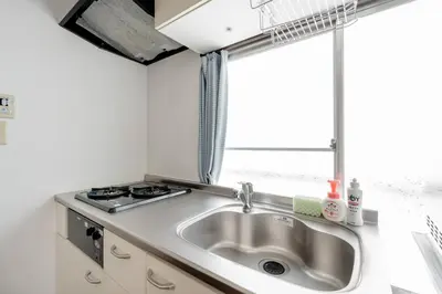 a kitchen with a sink and a window at Chelsea Hatsudai 201 CH21 in Tokyo